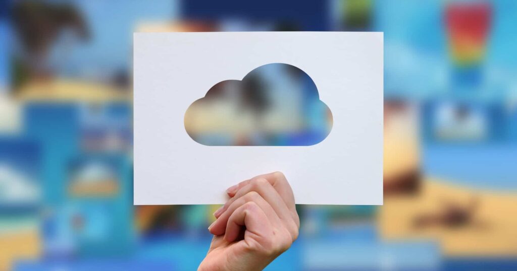 Female hand holding cloud perforated paper craft